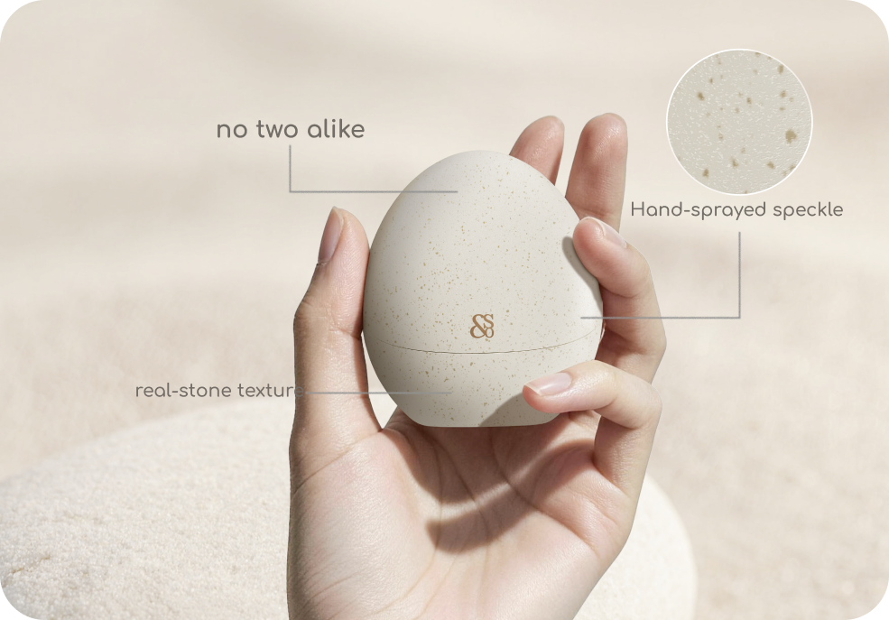 A hand holding the SoClip Pebble charging case